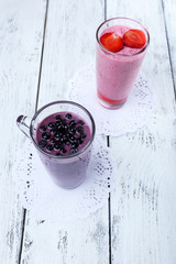 Delicious berry smoothie on table, close-up