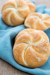 Homemade fresh bread buns  on old wooden table, selective focus