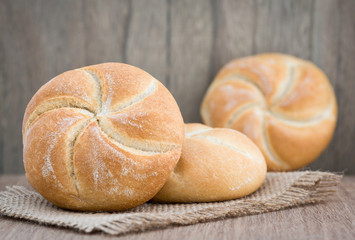 Homemade fresh bread buns  on old wooden table, selective focus
