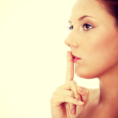 Young woman gesturing for quiet