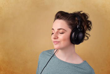 Young woman with headphones listening to music with copy space