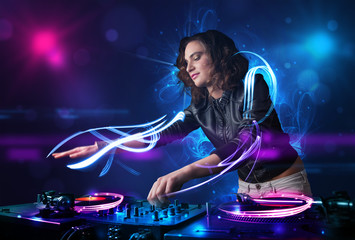 Fototapeta na wymiar Disc jockey playing music with electro light effects and lights
