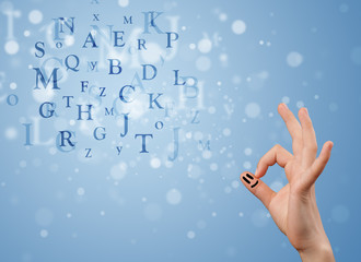 Happy smiley fingers looking at mixture of bokeh letters