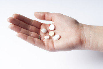 Hand with medicines isolated on white.