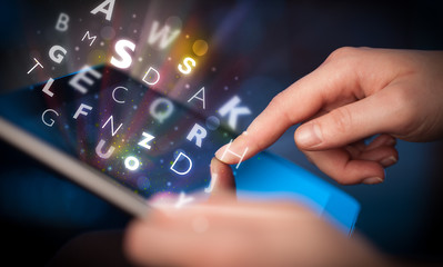 Finger pointing on tablet pc, letters concept