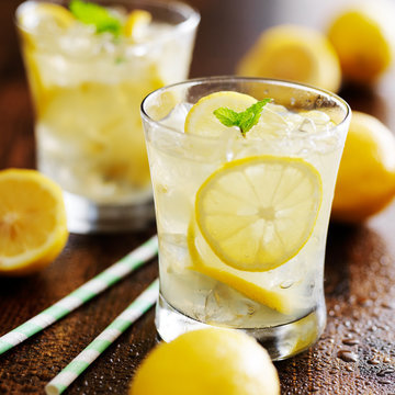 a front view lemon cocktail fresh cool drink inside glass cups sliced  lemons on the dark background Stock Photo by ImgSolut