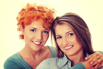 Two pretty girl friends smiling