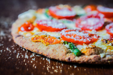 Ancient pizza with tomatoes and asparagus