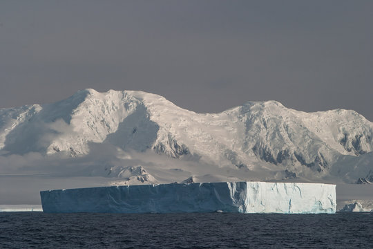 Iceberg and Antarctic Mountains