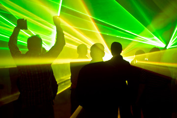 lasers at a nightclub and people silhouettes