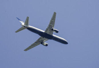 Flying plane on blue sky background