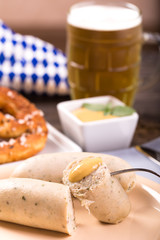 White sausages with mustard on plate