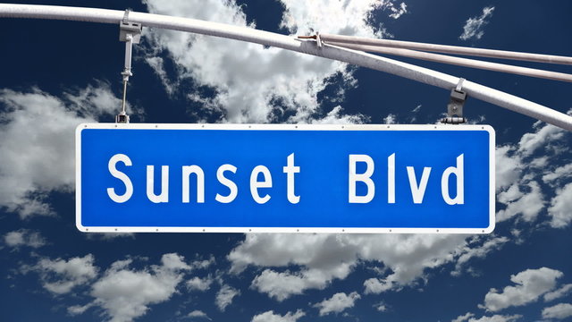 Sunset Blvd sign with time lapse clouds.