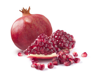 One whole pomegranate and piece isolated on white background