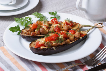 Stuffed aubergine with meat and tomatoes on the table