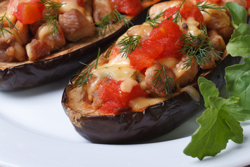 half baked aubergine with meat, cheese and tomatoes