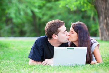 Teen couple with gift in the park.