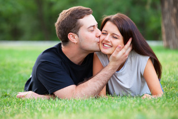 Teen couple with gift in the park.