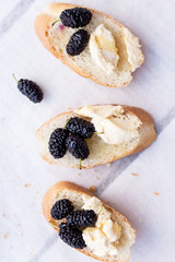 snack on french baguette on a wooden board