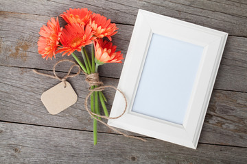 Bunch of gerbera flowers and photo frame