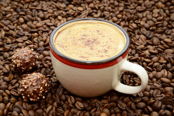 cup of coffee with cinnamon and candies