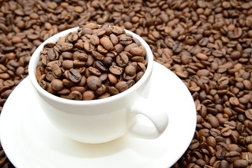 cup with coffee grains on a saucer, view from the top
