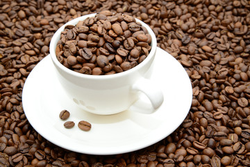 cup with coffee grains on a saucer