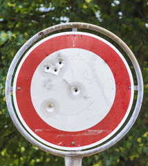 No vehicles traffic sign with bullet hole