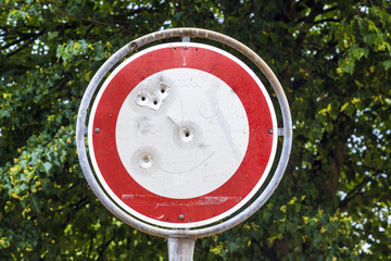 No vehicles traffic sign with bullet hole