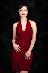 Fototapeta premium Retro style brunette woman posing over black background