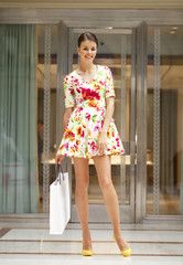 Young beautiful woman in red flowers dress