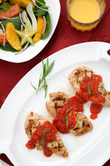 Grilled chicken breast with tomato tarragon sauce.