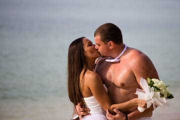 Kissing newlyweds at wedding day outdoors