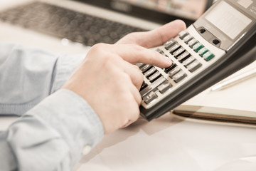 Businessman analyzing investment charts with laptop