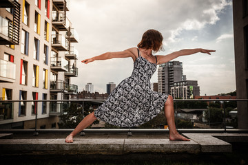 Young woman doing yoga on roof top