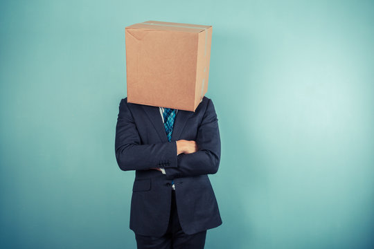Businessman with a box on his head