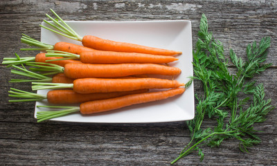 baby carrots on a white plate