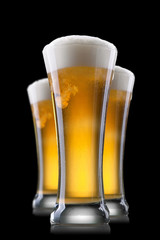 Beer in glass isolated on black