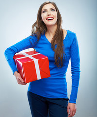 Fototapeta premium Portrait of young happy smiling woman hold red gift box. Isolat