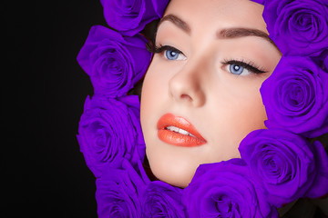 Fashion model portrait with  purple roses