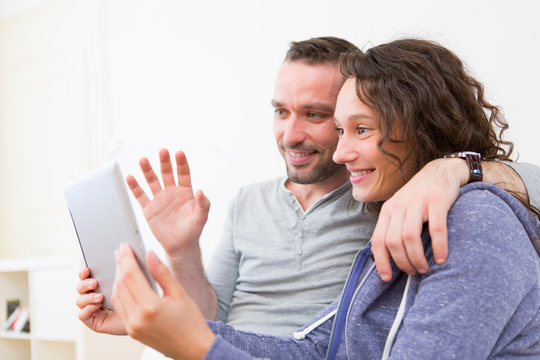 Young Happy Couple Video Calling On Tablet