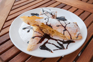 Piece of cherry strudel with chocolate.