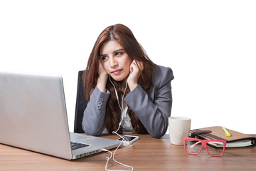 Brunette businesswoman with listening music on the desk