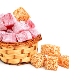 Turkish sweet delights in icing sugar in the basket isolated on