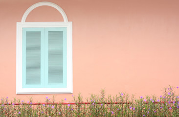 pastel blue window with white frame on pink wall
