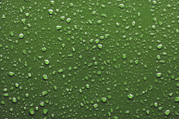 Fototapeta na wymiar Raindrops on green background
