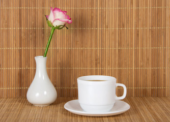 Vase with rose and cup