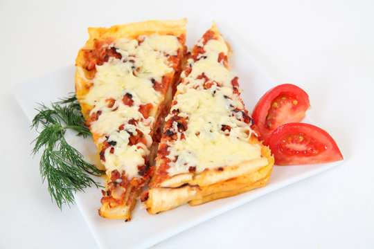 Italian lasagna with decoration on white plate