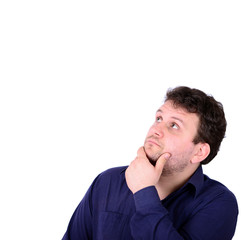 Portrait of chubby young man looking above and thinking about so