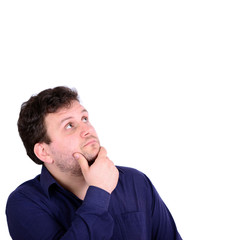 Portrait of chubby young man looking above and thinking about so